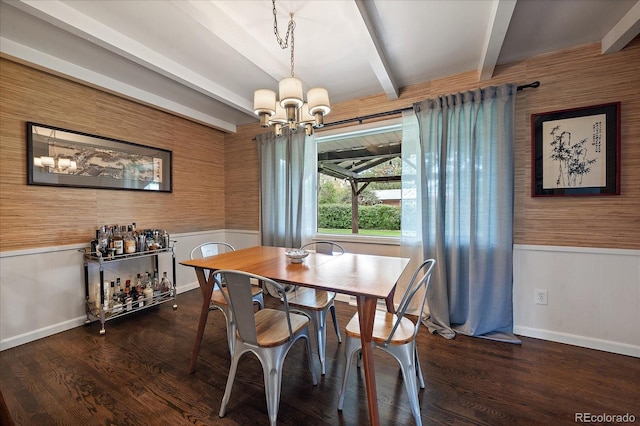 dining space with dark wood-type flooring, a notable chandelier, and beam ceiling