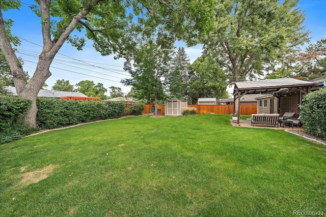 view of yard with a gazebo, a patio, a storage unit, and outdoor lounge area