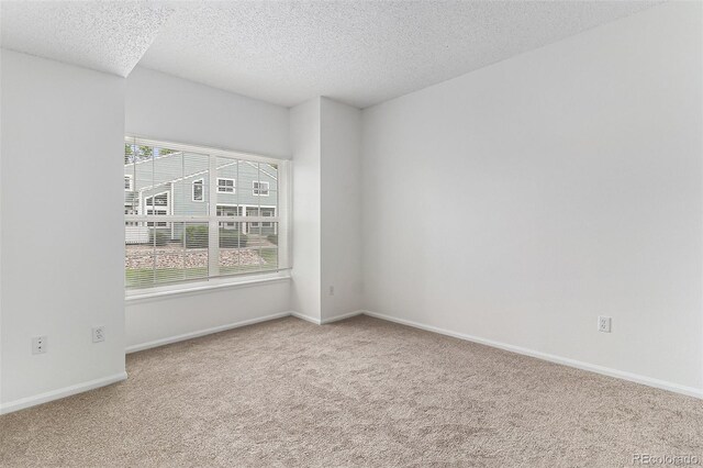 7453 Singing Hills Dr Unit E105, Boulder, CO 80301 - carpeted spare room featuring a textured ceiling and baseboards