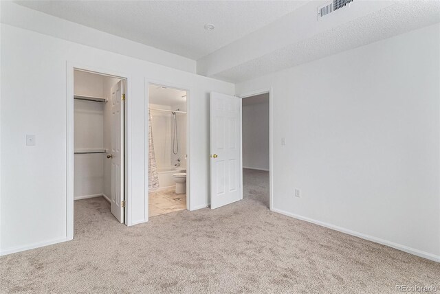 7453 Singing Hills Dr Unit E105, Boulder, CO 80301 - unfurnished bedroom featuring carpet floors, a walk in closet, baseboards, a closet, and ensuite bathroom