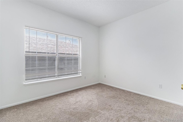 7453 Singing Hills Dr Unit E105, Boulder, CO 80301 - carpeted spare room featuring baseboards and a textured ceiling