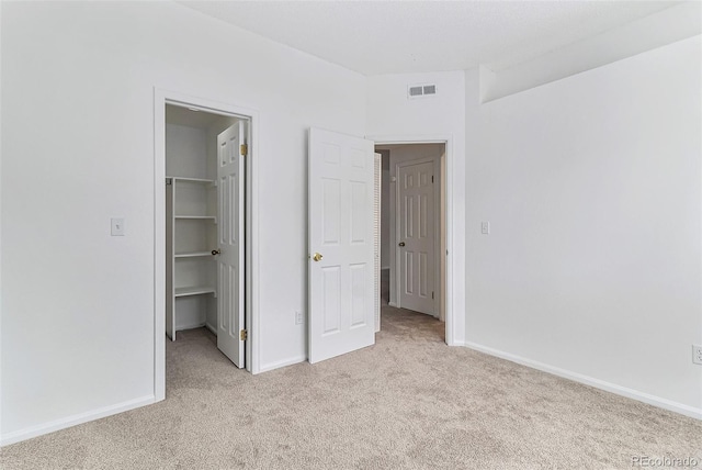 7453 Singing Hills Dr Unit E105, Boulder, CO 80301 - unfurnished bedroom featuring light colored carpet, a walk in closet, baseboards, and a closet