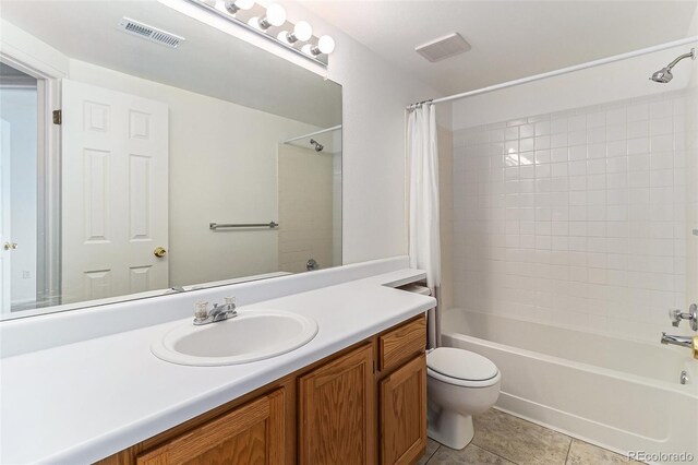7453 Singing Hills Dr Unit E105, Boulder, CO 80301 - bathroom featuring toilet, shower / tub combo with curtain, vanity, and tile patterned floors