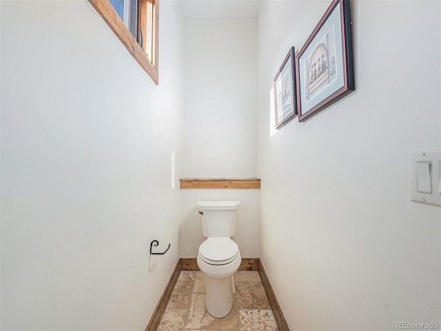 bathroom with toilet and tile floors