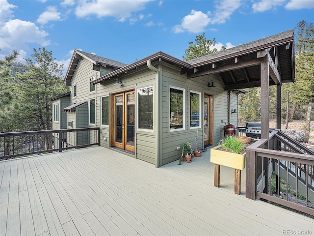 wooden deck with a grill