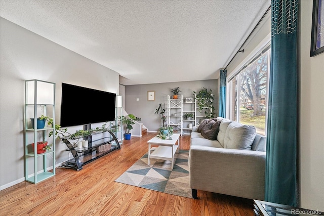 living room with hardwood / wood-style floors and a textured ceiling