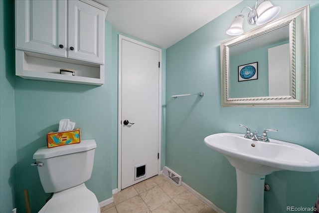 bathroom with tile patterned flooring, toilet, and sink