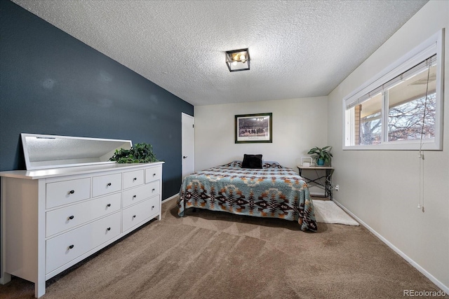 bedroom with carpet floors and a textured ceiling