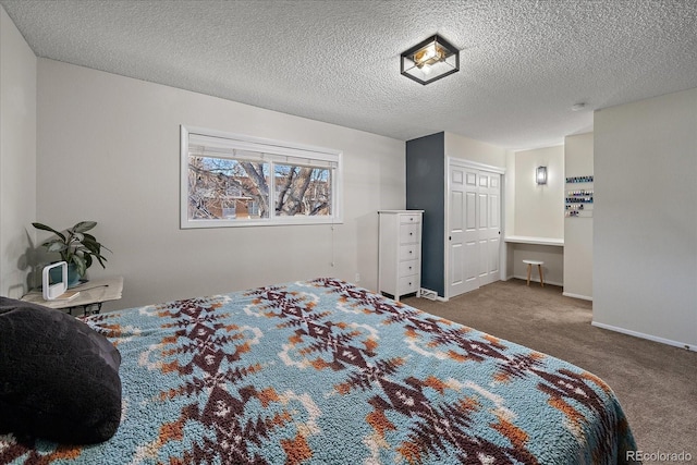 bedroom with carpet floors and a textured ceiling