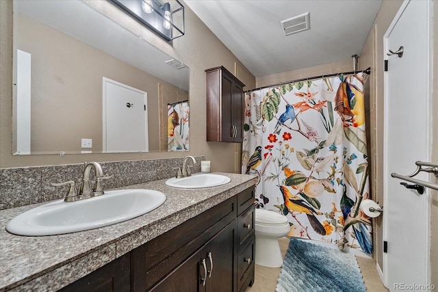 bathroom featuring a shower with curtain, tile patterned flooring, a textured ceiling, toilet, and vanity