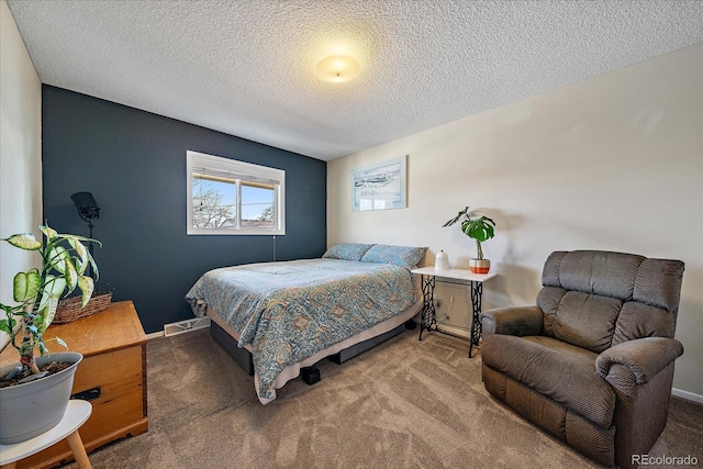 bedroom with carpet and a textured ceiling