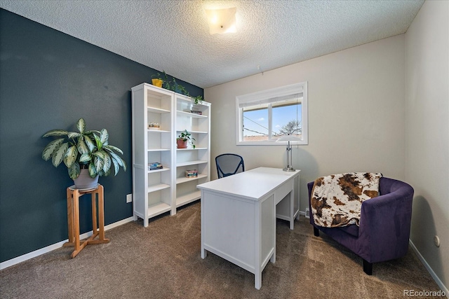 office with dark colored carpet and a textured ceiling