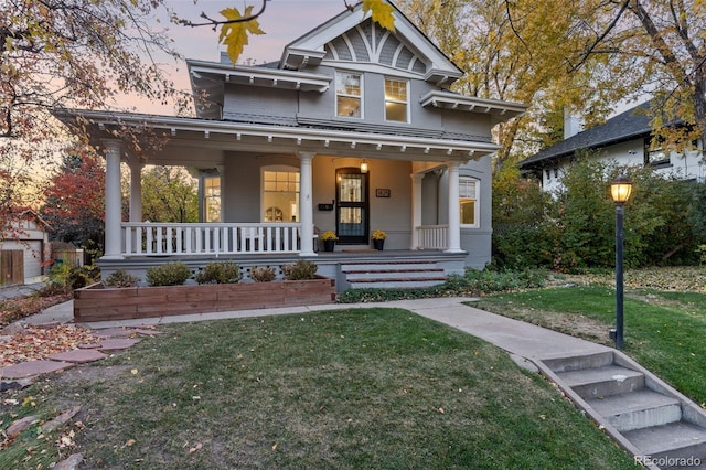 view of front of house with a lawn and covered porch