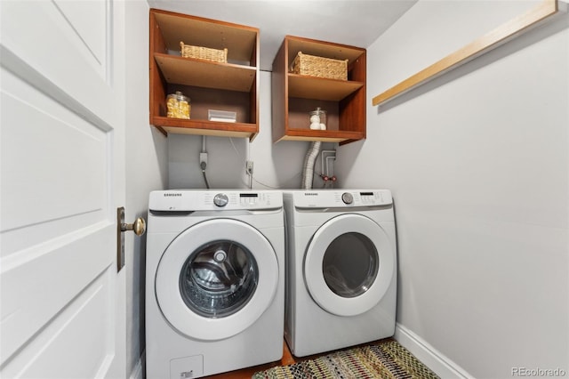 clothes washing area featuring washer and dryer