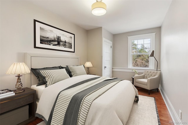 bedroom with hardwood / wood-style flooring