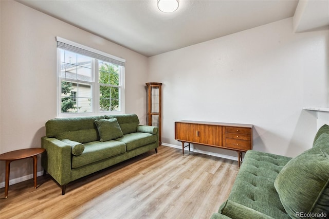 living area with light wood-style floors and baseboards