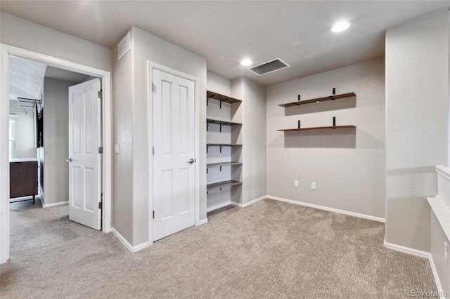 unfurnished bedroom featuring carpet floors, recessed lighting, visible vents, and baseboards