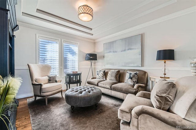 living room featuring dark hardwood / wood-style flooring, ornamental molding, and a raised ceiling