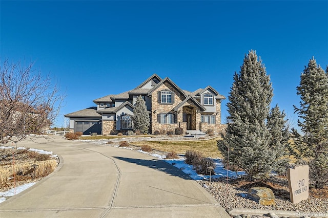15102 Prairie Pl, Broomfield, CO 80023 - view of front of property featuring stone siding, a garage, and concrete driveway