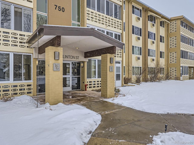 view of snow covered property entrance