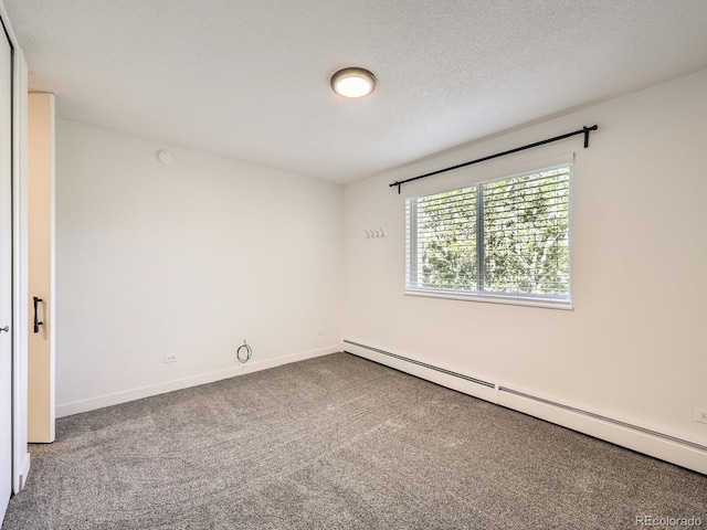 750 S Clinton St Unit 2C, Denver, CO 80247 - carpeted empty room featuring a baseboard radiator and baseboards