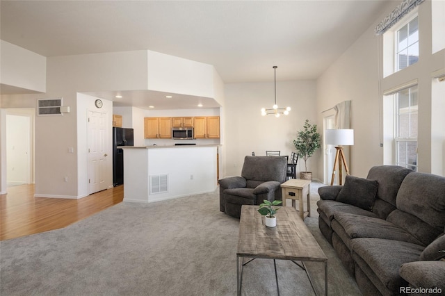 living room with light carpet, an inviting chandelier, visible vents, and recessed lighting