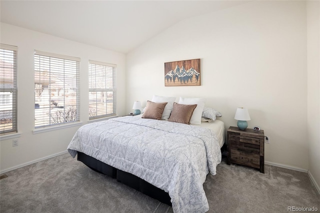 carpeted bedroom with lofted ceiling and baseboards