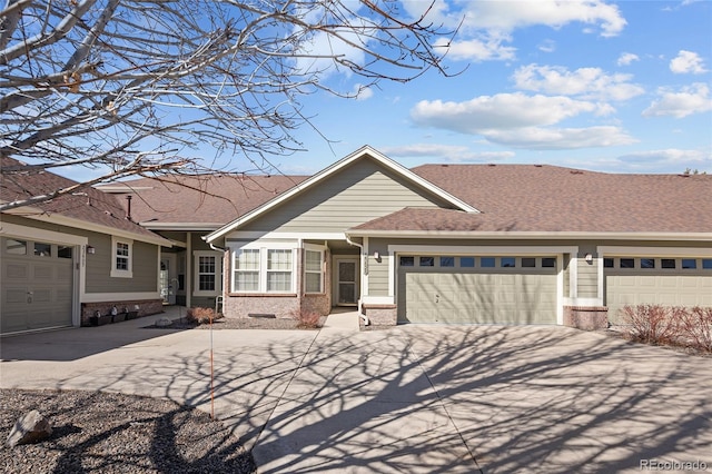 view of front of house with concrete driveway, brick siding, an attached garage, and a shingled roof