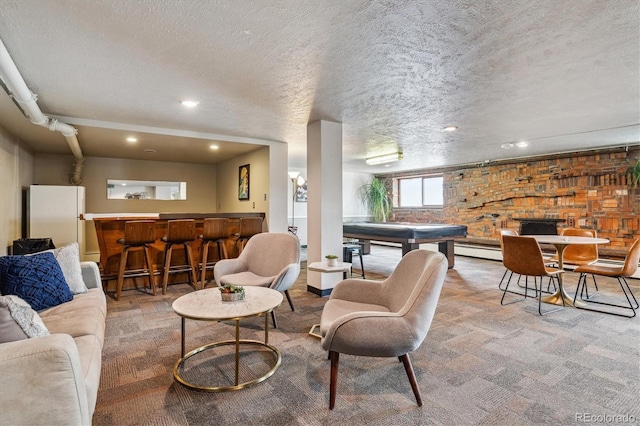 living room featuring a dry bar, a textured ceiling, recessed lighting, carpet flooring, and a baseboard heating unit