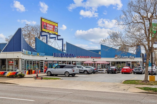 view of building exterior featuring uncovered parking