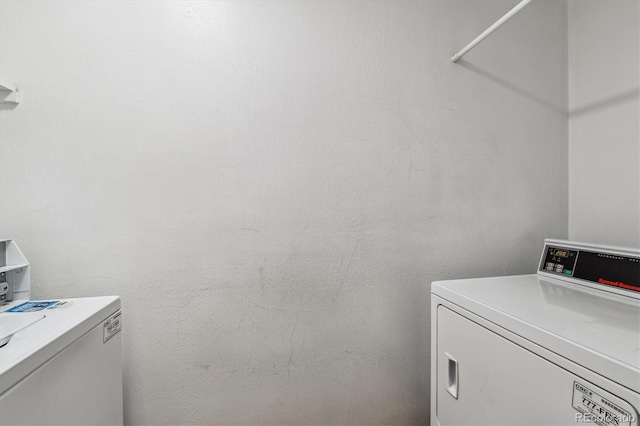 clothes washing area featuring washer and dryer and laundry area