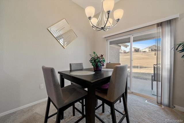 dining area with a chandelier, light colored carpet, visible vents, and baseboards