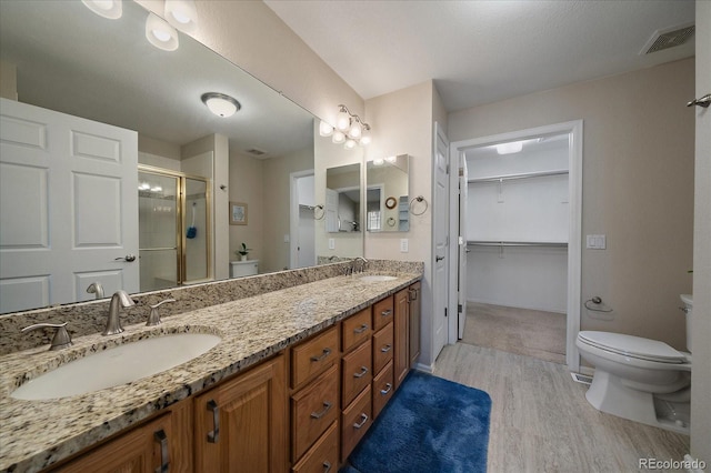 bathroom with visible vents, a sink, and toilet