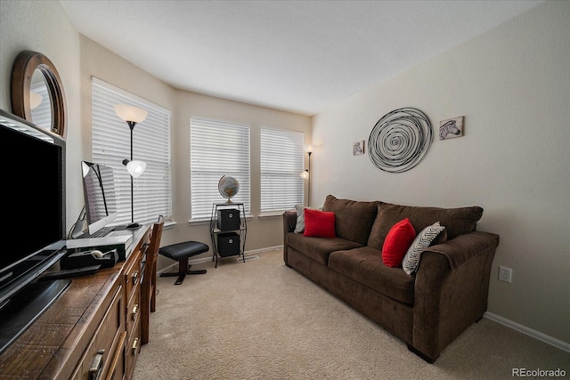 living room featuring light carpet and baseboards