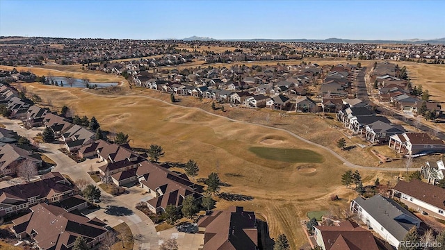 drone / aerial view with view of golf course and a residential view