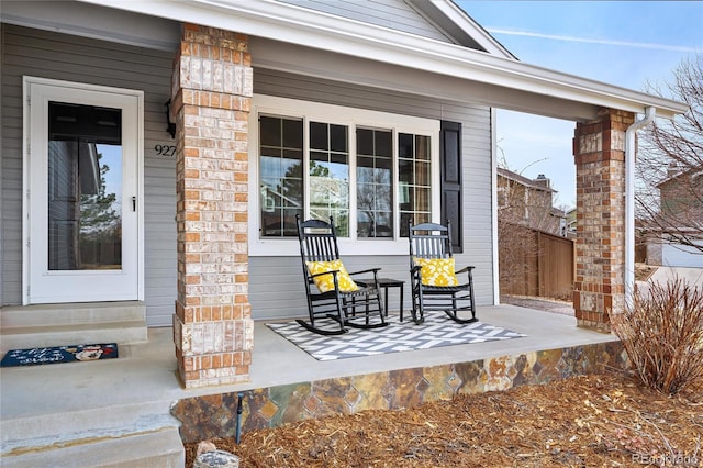 view of patio / terrace featuring covered porch and fence