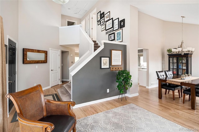 interior space featuring stairs, wood finished floors, and high vaulted ceiling