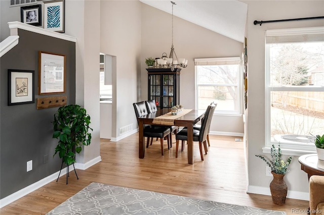 dining room featuring visible vents, an inviting chandelier, baseboards, and light wood-style floors