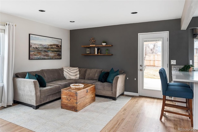 living room featuring light wood-style flooring and baseboards