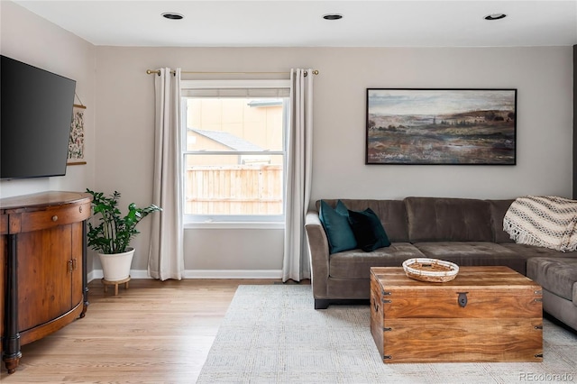 living room featuring recessed lighting, light wood-type flooring, and baseboards