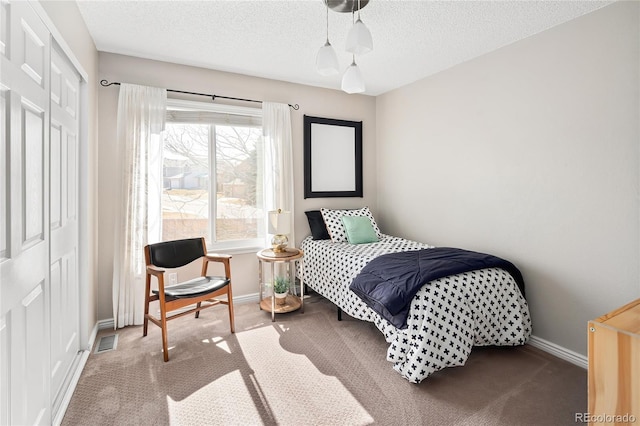 bedroom with carpet, visible vents, a closet, and baseboards