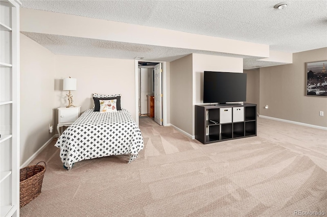 carpeted bedroom featuring baseboards and a textured ceiling