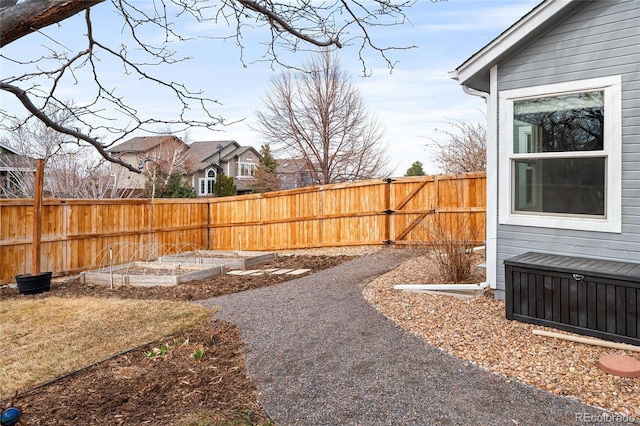 view of yard featuring a vegetable garden and fence private yard