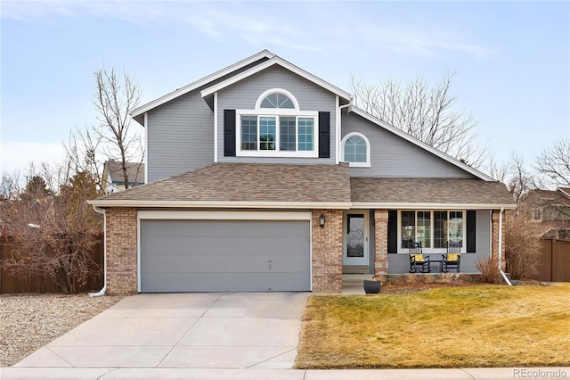 view of front of house featuring a garage, covered porch, brick siding, and driveway