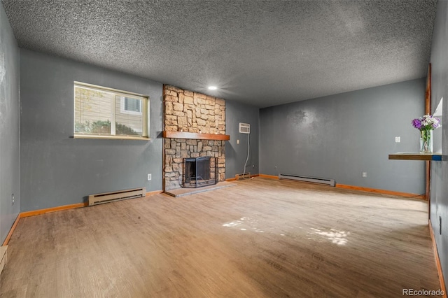 unfurnished living room with a textured ceiling, hardwood / wood-style flooring, and a baseboard heating unit