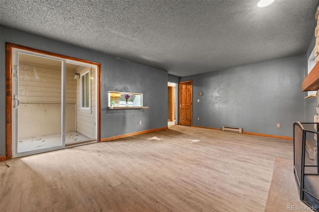 unfurnished living room with light hardwood / wood-style flooring, a textured ceiling, and a baseboard heating unit