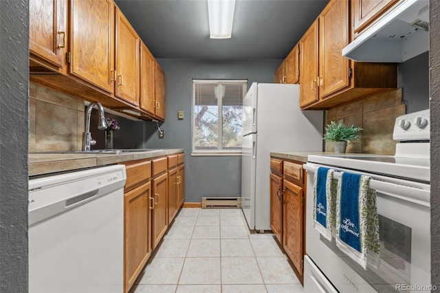 kitchen with tasteful backsplash, white appliances, sink, light tile patterned floors, and a baseboard radiator