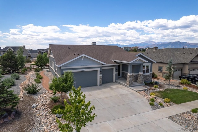 1849 Mud Hen Dr, Colorado Springs, CO 80921 - craftsman-style house with an attached garage, driveway, stone siding, and roof with shingles