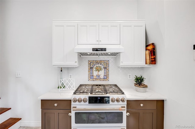 3106 N Franklin St, Denver, CO 80205 - kitchen with white gas range oven, exhaust hood, tasteful backsplash, light stone countertops, and white cabinetry