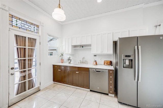 3106 N Franklin St, Denver, CO 80205 - kitchen featuring appliances with stainless steel finishes, ornamental molding, light countertops, white cabinetry, and pendant lighting